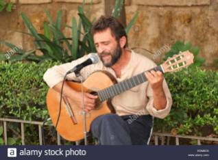 spanish-singer-and-guitar-player-performing-in-the-centre-of-seville-EDM6C6